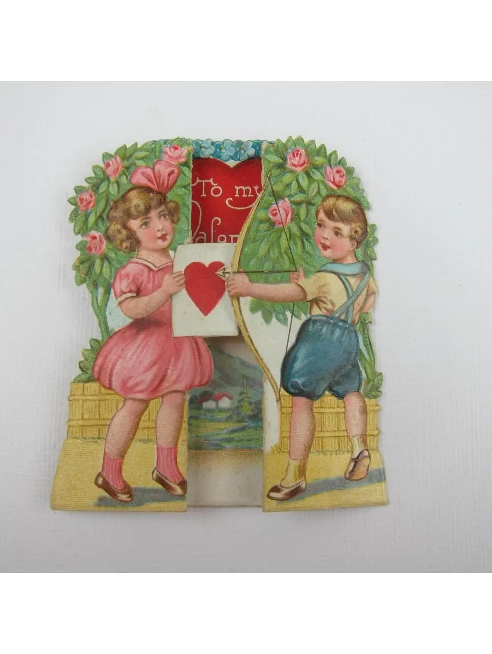 Vintage Valentine Boy Shoots Arrow Girl Pink Dress Holds Heart Target Mountains